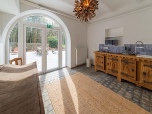A modern kitchen with a wooden cabinet, a microwave, and a sink. - Luxury Chalet in Jalhay With Private Sauna (Jalhay)