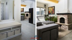 Un salon moderne avec une cheminée, un canapé gris et un grand miroir.