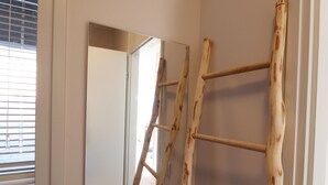 A wooden ladder leaning against a wall in a hallway. - Sunny Apartment Directly on the Heegermeer (Heeg)