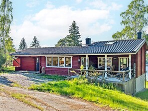 A single-story wooden house with a porch, a garage, and a chimney. - 4 Star Holiday Home in Varmdo (Fågelbrolandet)