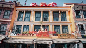A two-story building with a sign for 'Roudha Stupa Restaurant Guest House' and 'Rimthim'. - Boudha Stupa View Guest House (Kathmandu)