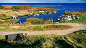 A coastal marina with boats docked, a clear sky, and a grassy landscape. - 4 Star Holiday Home in Hvide Sande (Hvide Sande)