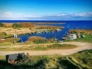 A coastal marina with boats docked, a clear sky, and a grassy landscape. - 4 Star Holiday Home in Hvide Sande (Hvide Sande)