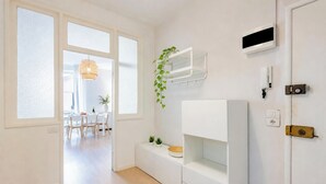 A modern kitchen with white cabinetry, a hanging plant, and a built-in TV. - Cozy Maria Apartment in Portofino, Portofino, Italy (Portofino)