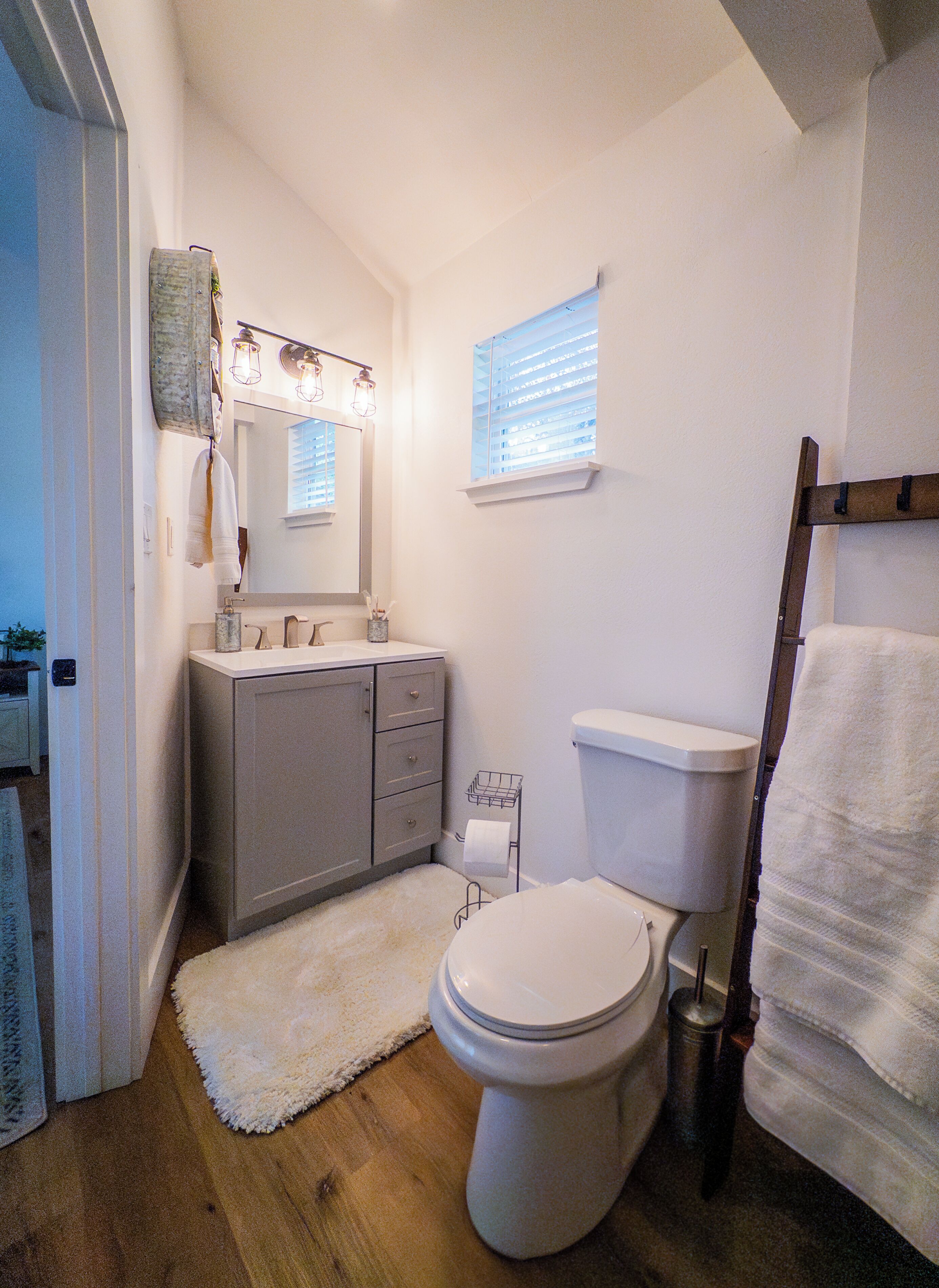 Une petite salle de bain comprenant des toilettes, un lavabo et un miroir.