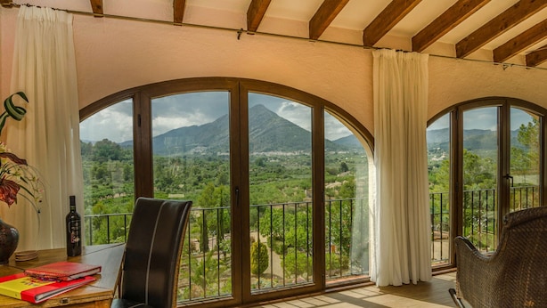 A balcony with a view of a mountainous landscape.