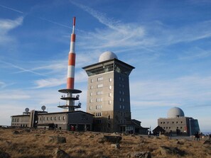 A building with a tall tower, a dome, and a flat-roofed structure. - Sports Chalet No. 19 (Ilsenburg)