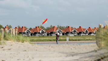 A beach with houses in the background.