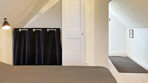 A room with a bed, a door, a window, and a light fixture. - 4 Star Holiday Home in Ahus (Aahus)