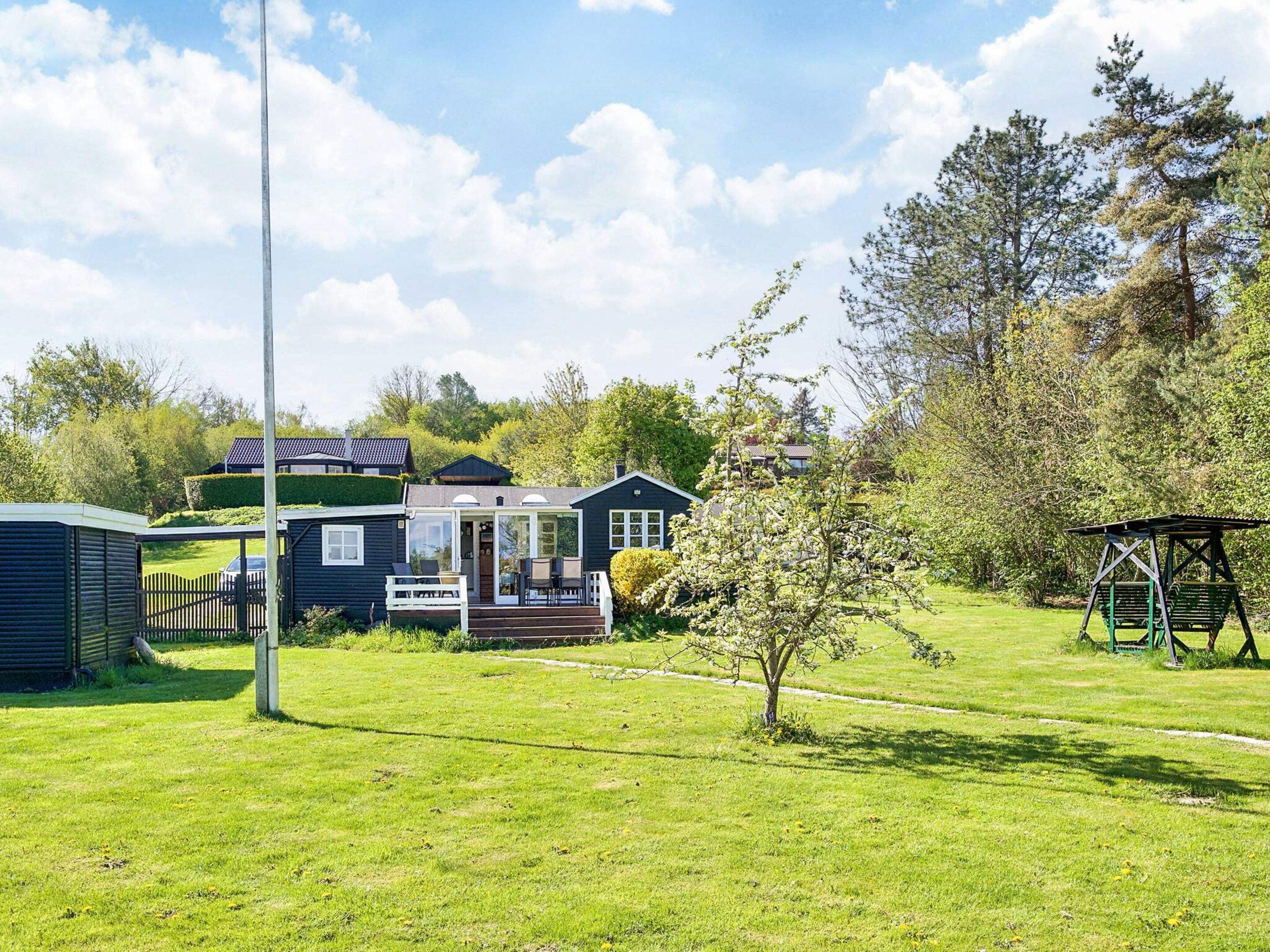 A residential property with a house, a fenced yard, and a small garden area.
