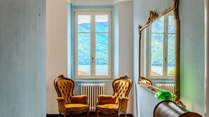 A room with two ornate chairs, a large mirror, and a radiator. - Regina 29 by Interhome (Tremezzina)