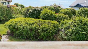 A well-maintained garden with various shrubs and a small stream. - 6 Person Holiday Home in Varberg-by Traum (Varberg)