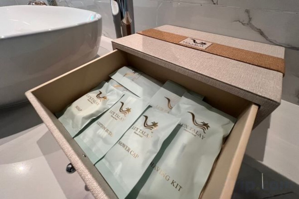 A drawer with multiple packages labeled 'HOT TAIL' and 'HOT TAIL KIT' in a bathroom setting.