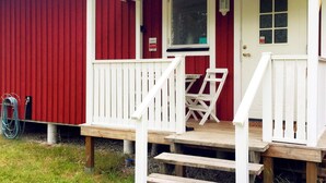 A red building with a white porch, a door, and a window. - 4 Star Holiday Home in Gotlands Tofta (Gotlands Tofta)