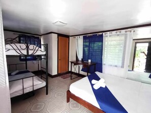 A room with bunk beds, a desk, and a window with curtains. - JVR Island in the Sky Resort (Balamban)