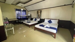 A hotel room with two beds, a small table, a chair, and a desk. - JVR Island in the Sky Resort (Balamban)