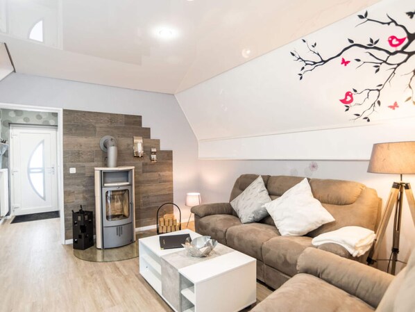 A modern living room with a fireplace, a sofa, and a coffee table.