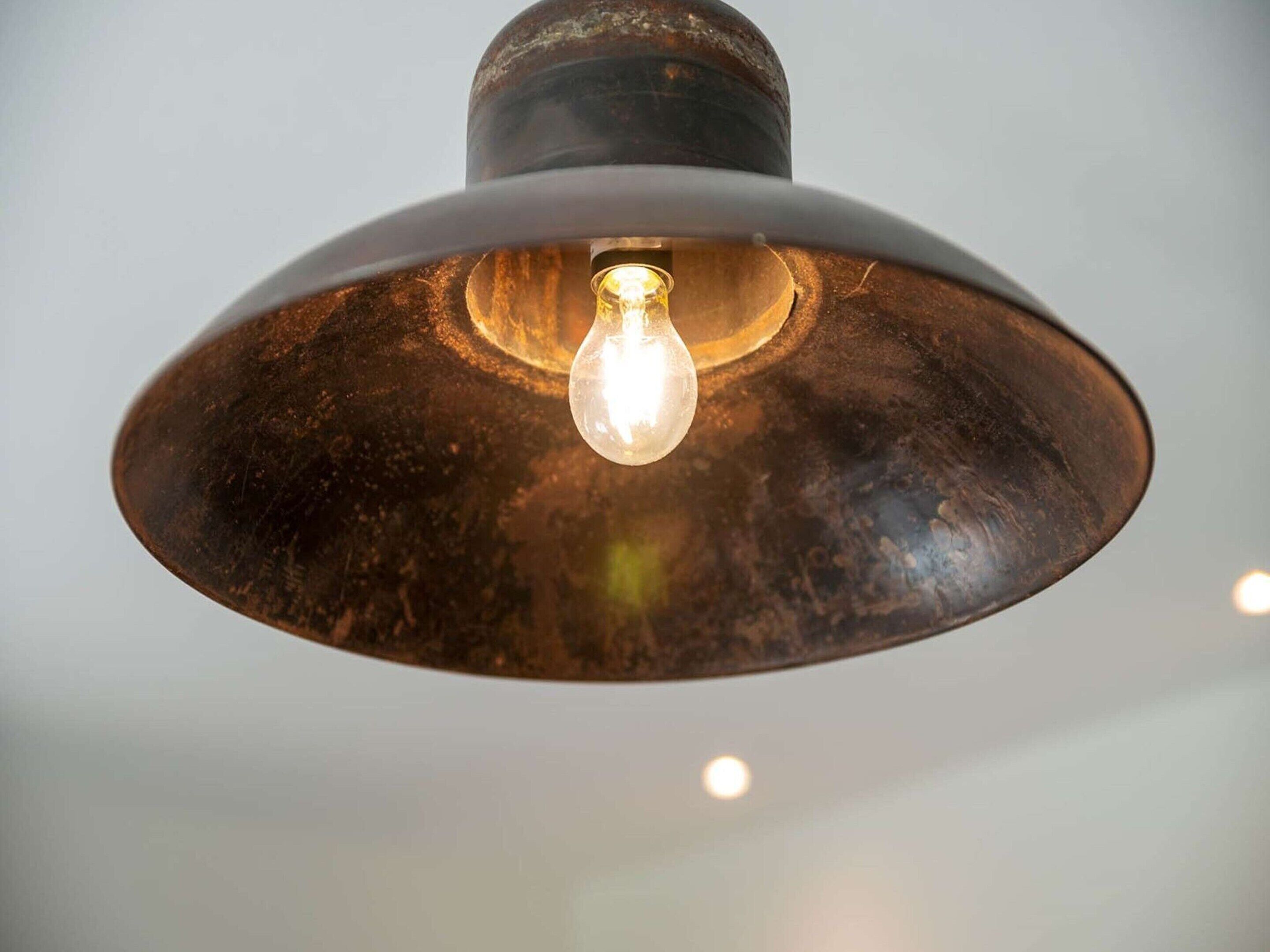 A close-up of a pendant light fixture with a single bulb.