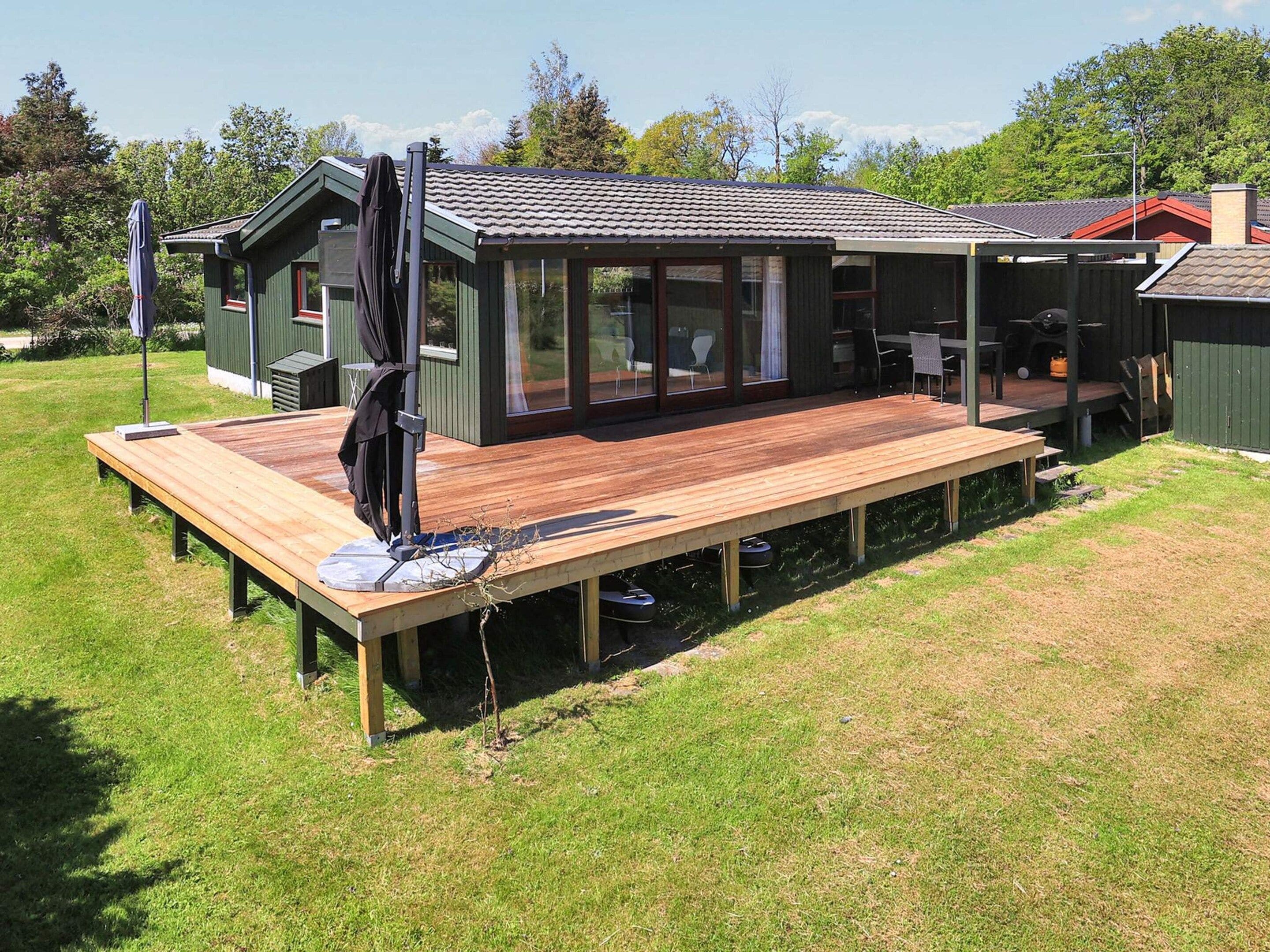 Une maison moderne dotée d’une terrasse, d’un patio couvert et d’un coin repas.