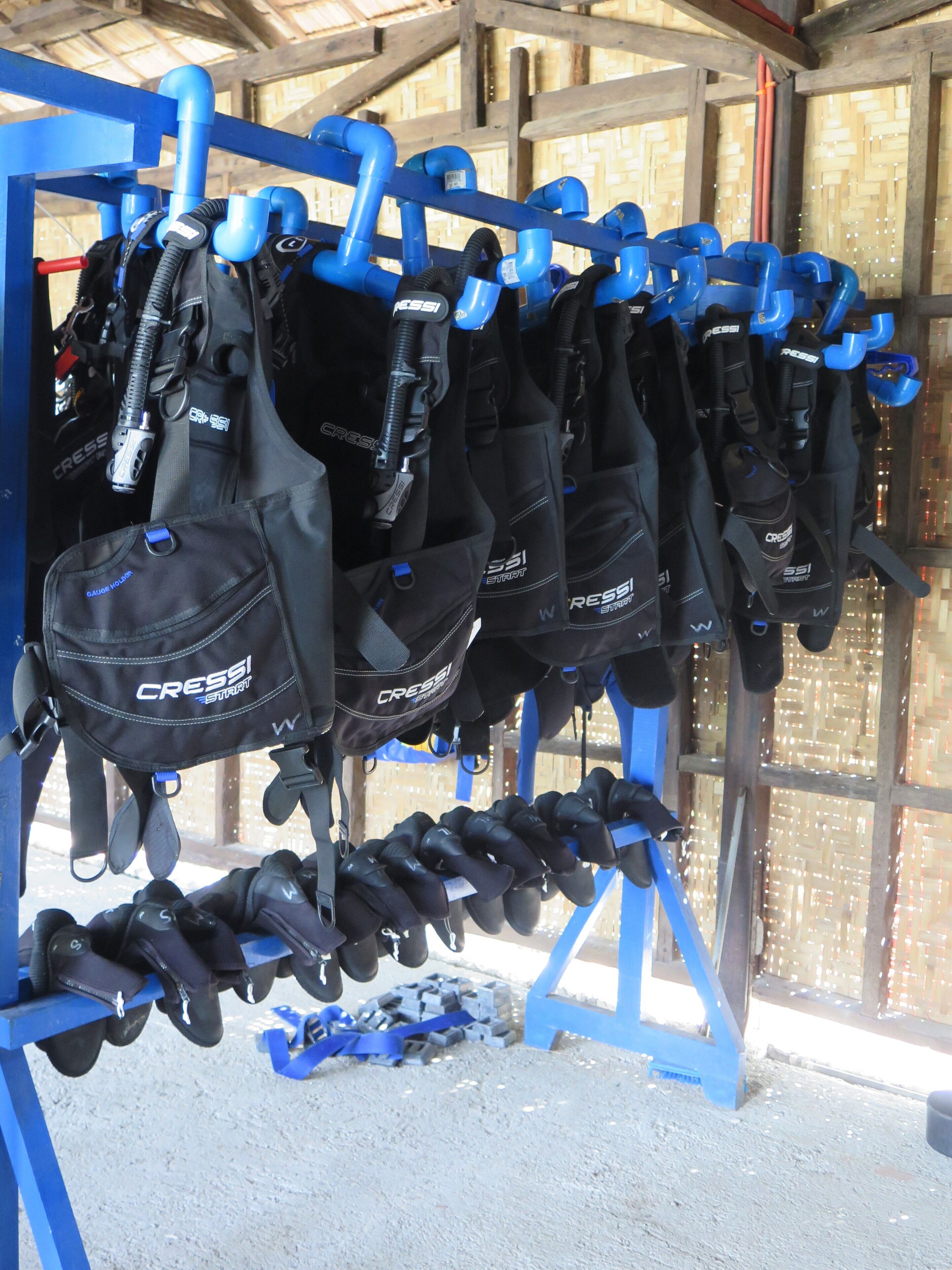 A rack with black bags and gloves hanging on hooks.