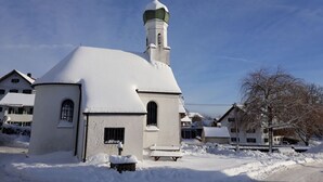 A church with a snow-covered dome and a tall tower.