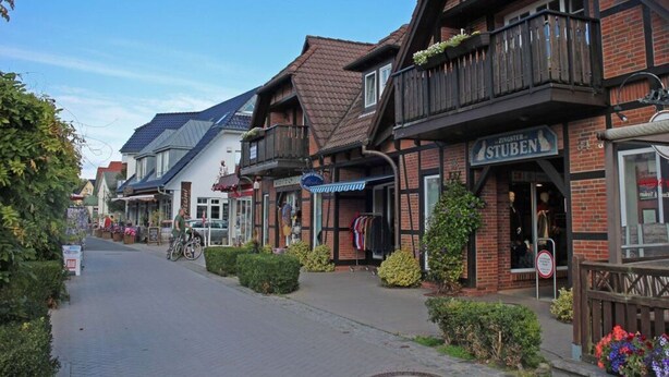 A street with traditional European architecture, including a building with a sign that reads "STUBEN".