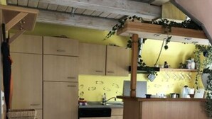 A kitchen with wooden cabinets, a sink, and a countertop. - Holiday Apartment Hinrichsen 2 (Midlum)