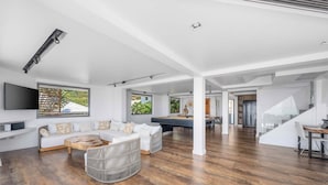 A spacious living area with a pool table, white sofas, and a wooden floor. - Serene Escape Villa in Chaweng - KBR20 (Koh Samui)