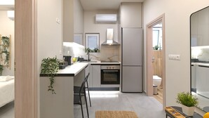 A compact kitchen with a built-in oven, a refrigerator, and a window above the sink.