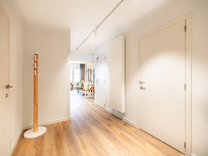 Enter a contemporary living space with a minimalist design, featuring a sofa, coffee table, and artwork.