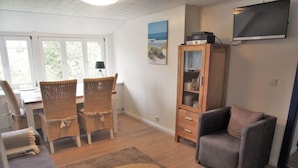 A living room with a sofa, two chairs, a small table, a cabinet, and a TV. - Holiday Apartment Strandkrabbe (Ockholm)