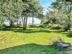 A grassy park area with trees and a stone bench. - 5 Star Holiday Home in Sydals (Sydals)