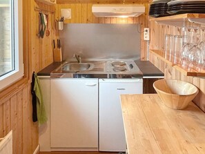 A compact kitchen with a sink, stove, and dishwasher.