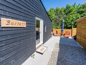A wooden exterior with a sign reading 'Basse' and a door. - 5 Star Holiday Home in Hemmet (Hemmet)