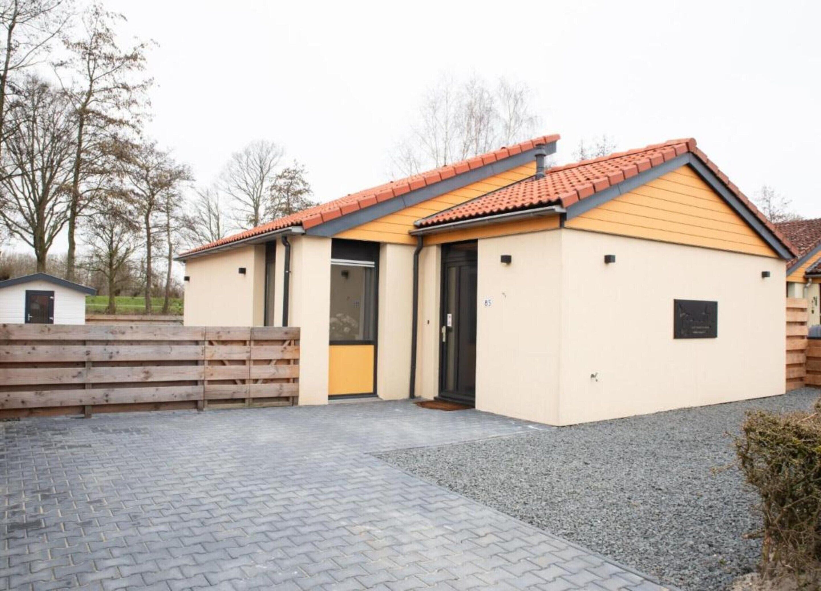 A small, single-story building with a tiled roof and a door.