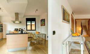 A modern kitchen with a central island, built-in oven, and a dining area with a glass table and chairs.