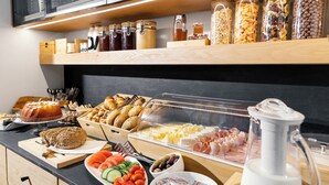 A buffet with various food items, including bread, pastries, and a variety of condiments. - Kenta Mountain Hotel (Volos)