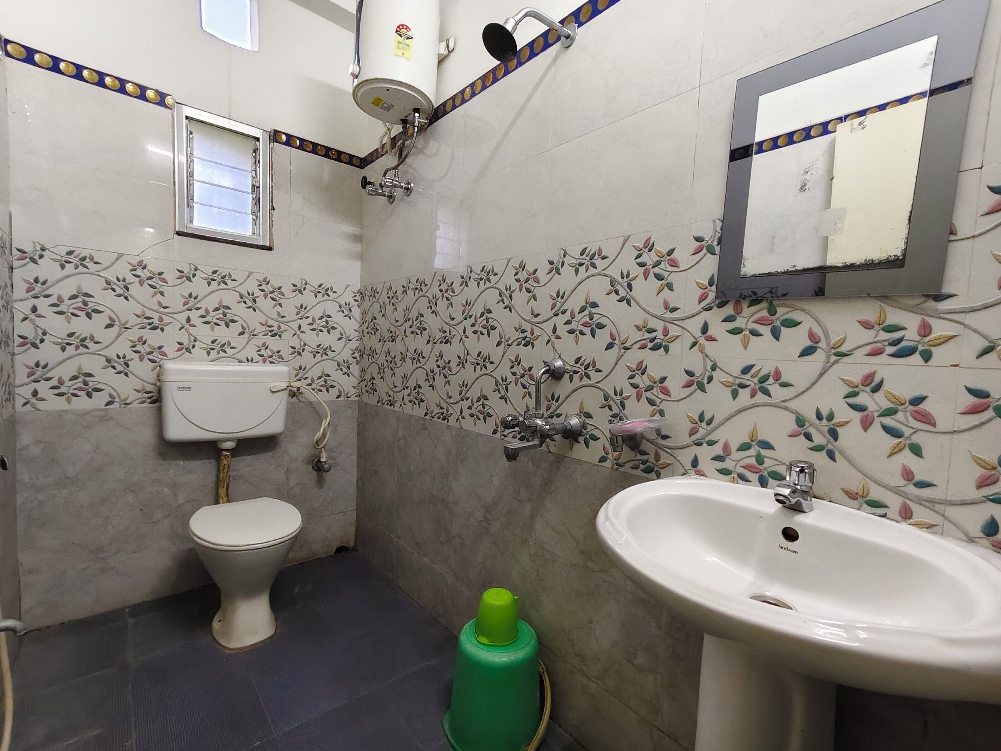 A bathroom with a toilet, sink, and shower.
