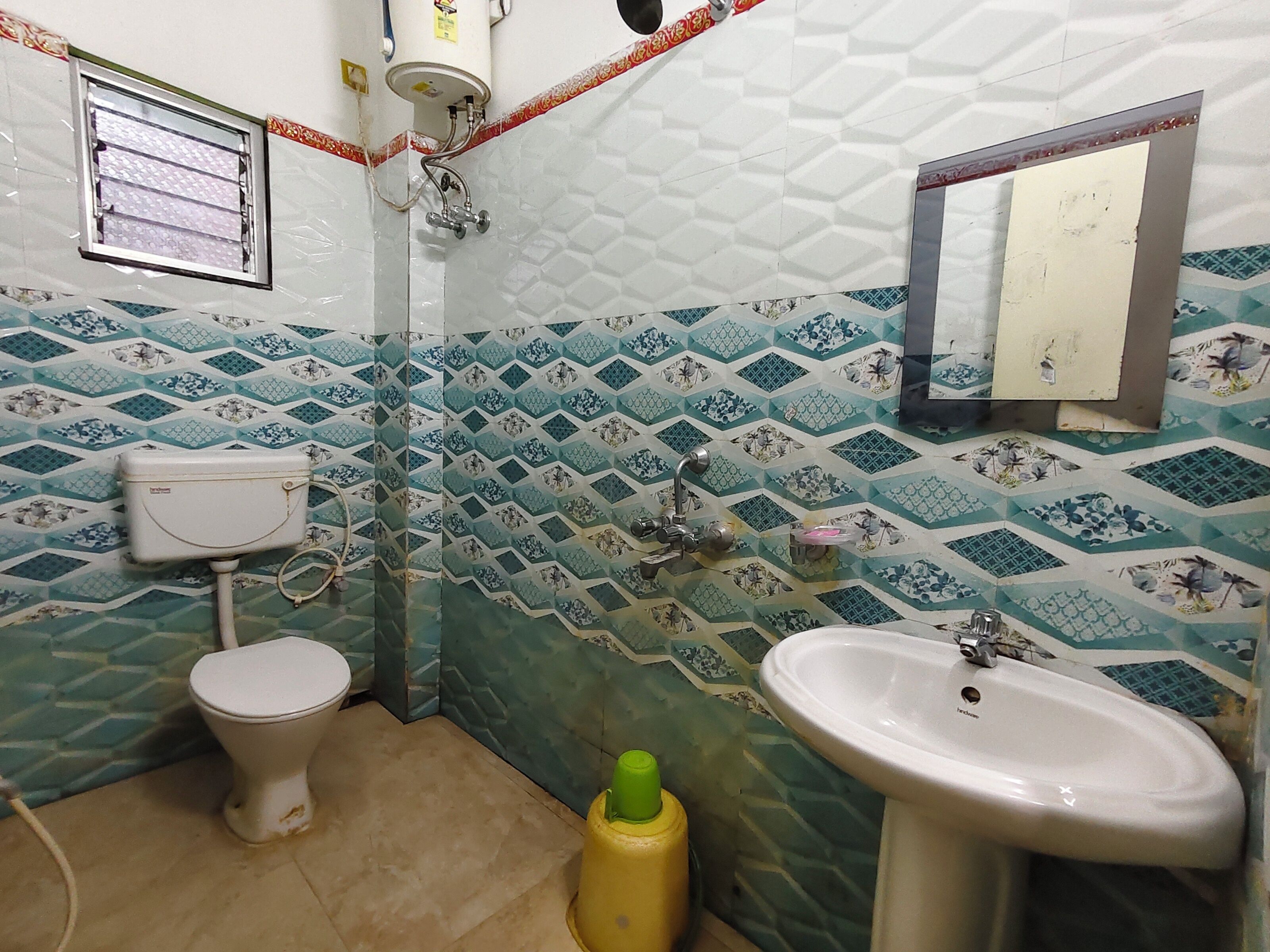 A bathroom with a toilet, sink, and shower.