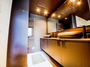 A modern kitchen with a built-in oven, a large island with a sink, and a microwave. - Maison Heurelijk Modern Finished Near Somme-leuze (Somme-Leuze)