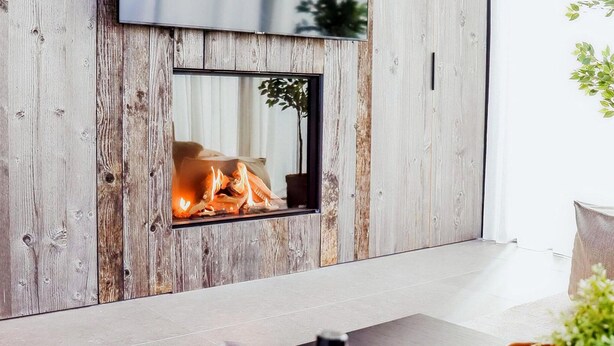 A modern living room with a built-in fireplace, wooden paneling, and a flat-screen TV mounted on the wall. - Maison Heurelijk Modern Finished Near Somme-leuze (Somme-Leuze)