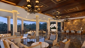 A spacious lobby with high ceilings, ornate chandeliers, and a large decorative wall. - Abisena Wellness & Resort Ubud-Adult Only (Tegallalang)