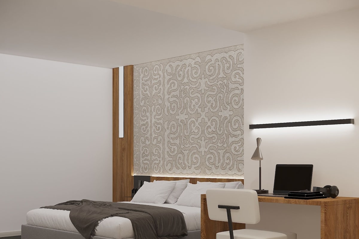 A modern bedroom with a bed, a desk, and a chair.