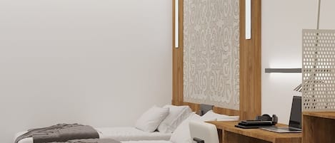A modern bedroom with a bed, a desk, and a chair.
