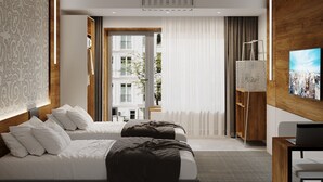A modern hotel room with a large bed, a desk, and a TV.