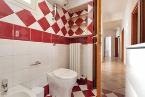 A bathroom with a white toilet, a sink, and a shower area. - 3900 Leccelsa Dimora by Barbarhouse (Lecce)