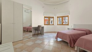 A bedroom with a bed, a desk, a chair, and a wardrobe. - 3900 Leccelsa Dimora by Barbarhouse (Lecce)