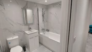 Basic Apartment, 2 Bedrooms | Bathroom | Combined shower/tub, free toiletries, towels, soap