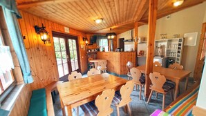 A wooden interior with a dining area, kitchen, and seating. - "sporthütten Nassau" Ihr Zentrales Domizil an der Blockline (Frauenstein)