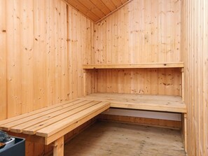 A sauna room with wooden walls and benches. - 8 Person Holiday Home in Norre Nebel (Norre Nebel)
